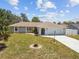 Lovely single-story home boasts an arched entryway, an attached garage, and a well-maintained lawn at 11280 Sedgefield Ave, Spring Hill, FL 34608