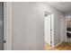 Hallway featuring wood-look floors and neutral paint, leading to various rooms in the home at 11280 Sedgefield Ave, Spring Hill, FL 34608