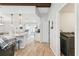 Hallway with laundry area, wooden-look floors, and views of kitchen and dining spaces at 11280 Sedgefield Ave, Spring Hill, FL 34608