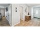 Hallway leading to various rooms, features wood-look flooring and neutral wall colors at 11280 Sedgefield Ave, Spring Hill, FL 34608