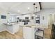 Bright and spacious kitchen features granite countertops, stainless steel appliances, and eat-in island at 11280 Sedgefield Ave, Spring Hill, FL 34608
