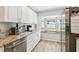 Stainless steel appliances and large windows highlight this bright kitchen at 11280 Sedgefield Ave, Spring Hill, FL 34608