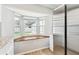 Bright kitchen nook with stainless steel refrigerator and a view of the screened-in lanai and pool at 11280 Sedgefield Ave, Spring Hill, FL 34608