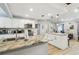 Open kitchen with granite countertop island and stainless steel appliances offers lots of light at 11280 Sedgefield Ave, Spring Hill, FL 34608