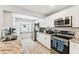Well-lit kitchen featuring stainless steel appliances and large window over the sink area at 11280 Sedgefield Ave, Spring Hill, FL 34608