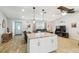 Bright, open-concept home with island, hardwood floors, large windows, and comfortable living room at 11280 Sedgefield Ave, Spring Hill, FL 34608