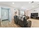 Spacious living room with leather reclining sofa, TV, and a view of the front door at 11280 Sedgefield Ave, Spring Hill, FL 34608