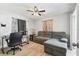 Cozy living room featuring wood-look flooring, a gray sofa, and a desk at 11280 Sedgefield Ave, Spring Hill, FL 34608