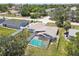 Aerial view featuring a screened-in pool and well-kept lawn, enhancing the home's outdoor appeal at 11280 Sedgefield Ave, Spring Hill, FL 34608