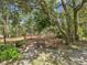 Peaceful backyard featuring a tranquil outdoor seating area with a bench and fountain at 12229 Barnevelde Rd, Weeki Wachee, FL 34614