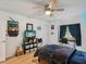 Bedroom with light wood flooring, a window with backyard views, and dark wood furnishings at 12229 Barnevelde Rd, Weeki Wachee, FL 34614