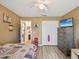 Cozy bedroom with light wood flooring, ample closet space, and ceiling fan for maximum comfort at 12229 Barnevelde Rd, Weeki Wachee, FL 34614