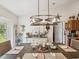 Dining room with a large table setting, modern lighting, and easy access to the kitchen and backyard at 12229 Barnevelde Rd, Weeki Wachee, FL 34614