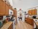 Functional kitchen with natural wood cabinets, laminate countertops, and appliances at 12229 Barnevelde Rd, Weeki Wachee, FL 34614