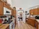 Well-designed kitchen featuring wood cabinets, laminate countertops, and updated appliances for a functional cooking space at 12229 Barnevelde Rd, Weeki Wachee, FL 34614