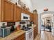 Functional kitchen with natural wood cabinets, laminate countertops, and appliances at 12229 Barnevelde Rd, Weeki Wachee, FL 34614