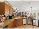 Charming kitchen featuring wood cabinets, laminate countertops, and stainless steel appliances, creating a warm and inviting atmosphere at 12229 Barnevelde Rd, Weeki Wachee, FL 34614