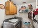 Efficient laundry room includes modern washer and dryer, cabinets, and ample storage for all your laundry needs at 12229 Barnevelde Rd, Weeki Wachee, FL 34614
