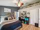 Stylish main bedroom features a ceiling fan, accent wall, and ample space, creating a comfortable personal sanctuary at 12229 Barnevelde Rd, Weeki Wachee, FL 34614