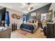 Inviting main bedroom showcases an accent wall, ceiling fan, and ensuite bathroom, offering a private retreat at 12229 Barnevelde Rd, Weeki Wachee, FL 34614