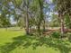 Well-maintained yard with lush green grass, mature landscaping, and natural privacy at 12229 Barnevelde Rd, Weeki Wachee, FL 34614