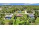 Aerial view showcasing the property's large lot, mature trees, and neighboring homes at 12323 House Finch, Weeki Wachee, FL 34614