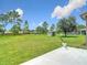 Expansive backyard featuring lush green grass, mature trees, and a storage shed at 12323 House Finch, Weeki Wachee, FL 34614