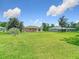 Sprawling backyard with mature trees, shed, and ample space for outdoor activities at 12323 House Finch, Weeki Wachee, FL 34614