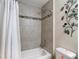 Bathroom featuring a shower with decorative tile design and white shower curtain at 12323 House Finch, Weeki Wachee, FL 34614