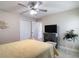 The bedroom has a closet, ceiling fan, television and neutral walls at 12323 House Finch, Weeki Wachee, FL 34614