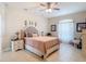 Bright bedroom features tile floors, neutral walls, and a decorative ceiling fan at 12323 House Finch, Weeki Wachee, FL 34614