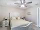 This bedroom features neutral tones, tile flooring, a ceiling fan and white furniture at 12323 House Finch, Weeki Wachee, FL 34614
