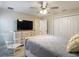 Bedroom featuring a bed with white wooden frame, patterned bedspread, and TV at 12323 House Finch, Weeki Wachee, FL 34614