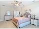 Cozy bedroom with tile flooring features a dresser, nightstands, and a comfortable bed at 12323 House Finch, Weeki Wachee, FL 34614