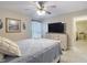 Bright bedroom with a ceiling fan, tile floors, comfortable bed, dresser and television at 12323 House Finch, Weeki Wachee, FL 34614