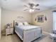Bedroom featuring a bed with white wooden frame, patterned bedspread, and matching nightstands at 12323 House Finch, Weeki Wachee, FL 34614