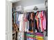Walk-in closet with wire shelving, colorful storage bins, and organized clothing at 12323 House Finch, Weeki Wachee, FL 34614