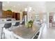 Bright dining area showcasing wood table, breakfast bar, and open floor plan to the living room at 12323 House Finch, Weeki Wachee, FL 34614