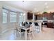 Bright dining area with a bay window, table with seating, adjacent to a kitchen with countertop bar seating at 12323 House Finch, Weeki Wachee, FL 34614