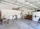 Spacious garage with ample storage, laundry area, and neutral-toned walls at 12323 House Finch, Weeki Wachee, FL 34614