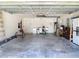 Spacious garage with epoxy flooring, white walls, and ample storage and work space at 12323 House Finch, Weeki Wachee, FL 34614