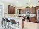 Stylish kitchen with granite counters, stainless steel appliances, and breakfast bar with seating at 12323 House Finch, Weeki Wachee, FL 34614