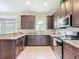 Modern kitchen featuring stainless steel appliances, granite countertops, and stylish cabinetry at 12323 House Finch, Weeki Wachee, FL 34614