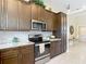 Kitchen featuring stainless steel appliances, granite countertops, and abundant cabinet storage at 12323 House Finch, Weeki Wachee, FL 34614