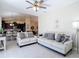 Expansive living room showcasing tile floors, neutral tones, and seamless transition to the dining and kitchen areas at 12323 House Finch, Weeki Wachee, FL 34614