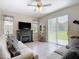 Relaxing living room features a fireplace, tile flooring, and a sliding glass door leading to the backyard at 12323 House Finch, Weeki Wachee, FL 34614