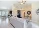 Open-concept living room featuring tile flooring, neutral decor, and views into the kitchen and dining areas at 12323 House Finch, Weeki Wachee, FL 34614