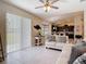 Bright living room featuring tile flooring, neutral decor, and sliding glass doors for indoor-outdoor living at 12323 House Finch, Weeki Wachee, FL 34614