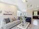 Spacious living room showcasing tile floors, comfortable seating, and views into the dining and kitchen areas at 12323 House Finch, Weeki Wachee, FL 34614