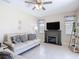 Comfortable living room with tile floors, fireplace, and abundant natural light creates an inviting atmosphere at 12323 House Finch, Weeki Wachee, FL 34614